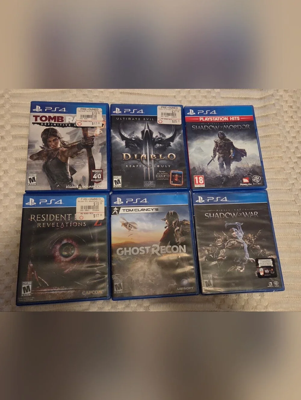 PS4 Game Lot — Blue Cases with Multi-Game Covers